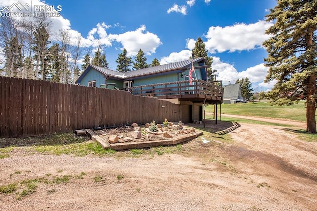 555 Elfin Glen Dr, Divide, CO 80814 - view of property exterior with fence, a deck, and metal roof
