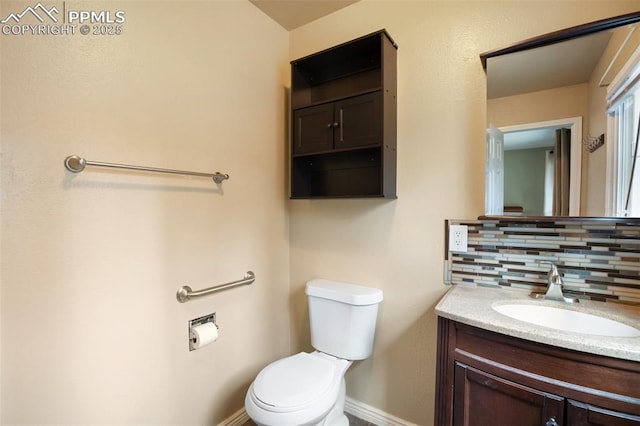 555 Elfin Glen Dr, Divide, CO 80814 - half bath with backsplash, toilet, vanity, and baseboards