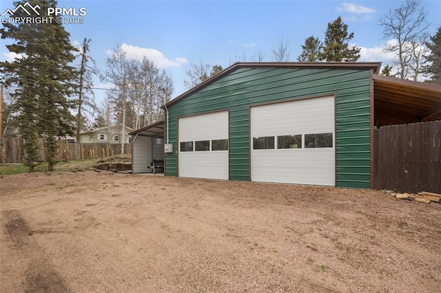 555 Elfin Glen Dr, Divide, CO 80814 - garage featuring fence, a detached garage, and driveway
