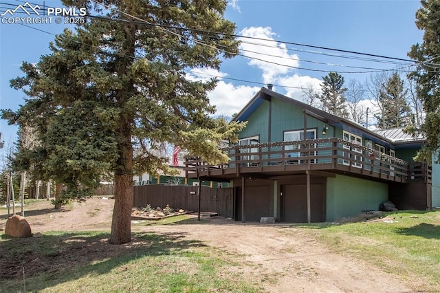 555 Elfin Glen Dr, Divide, CO 80814 - view of front of house featuring a wooden deck, driveway, and fence
