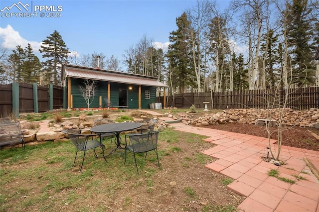 555 Elfin Glen Dr, Divide, CO 80814 - fenced backyard with an outdoor structure and a patio