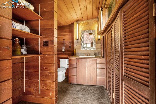1455 La Mesa St, Colorado Springs, CO 80904 - bathroom featuring toilet, vanity, wood ceiling, and wooden walls