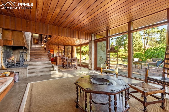 1455 La Mesa St, Colorado Springs, CO 80904 - living area featuring plenty of natural light, concrete floors, wood ceiling, stairs, and floor to ceiling windows