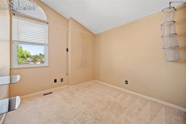 8545 Salsifa Ter, Colorado Springs, CO 80920 - carpeted empty room featuring vaulted ceiling, baseboards, and a textured ceiling