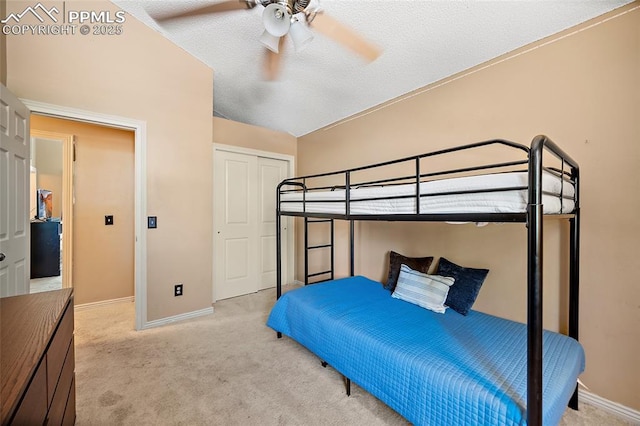 8545 Salsifa Ter, Colorado Springs, CO 80920 - bedroom with light colored carpet, baseboards, a closet, ceiling fan, and a textured ceiling