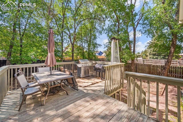 8545 Salsifa Ter, Colorado Springs, CO 80920 - wooden deck with outdoor dining area and a grill