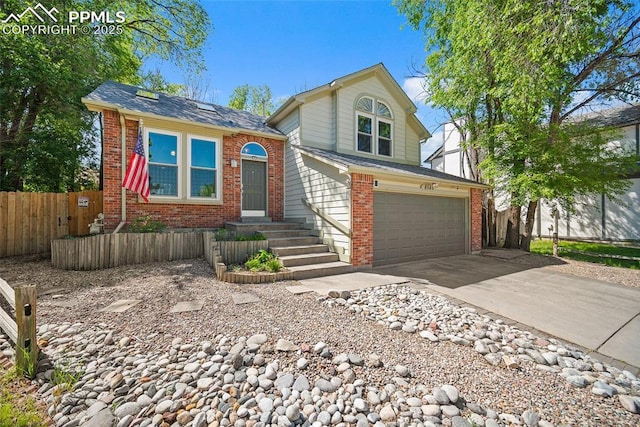 8545 Salsifa Ter, Colorado Springs, CO 80920 - view of front of home with brick siding, an attached garage, and driveway