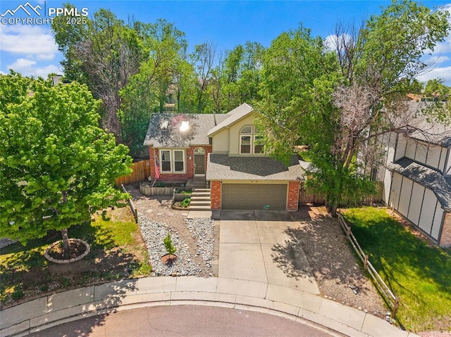 8545 Salsifa Ter, Colorado Springs, CO 80920 - view of front of property featuring brick siding, driveway, a garage, and roof with shingles