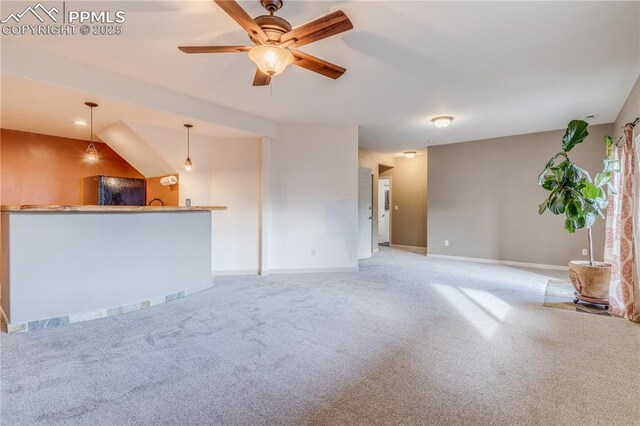 126 Star View Cir, Palmer Lake, CO 80133 - unfurnished living room with ceiling fan, baseboards, bar area, and carpet floors