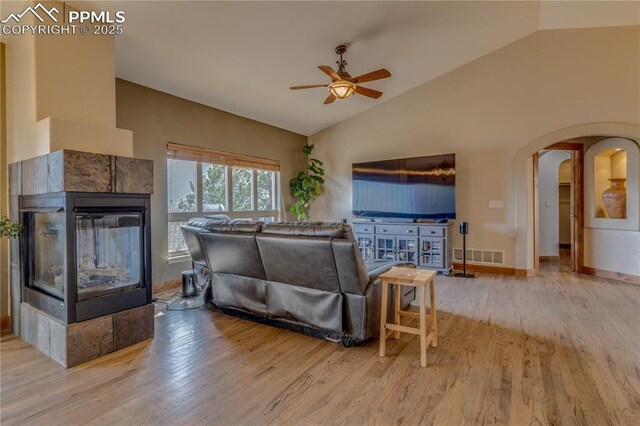 126 Star View Cir, Palmer Lake, CO 80133 - living room featuring visible vents, arched walkways, a ceiling fan, and lofted ceiling