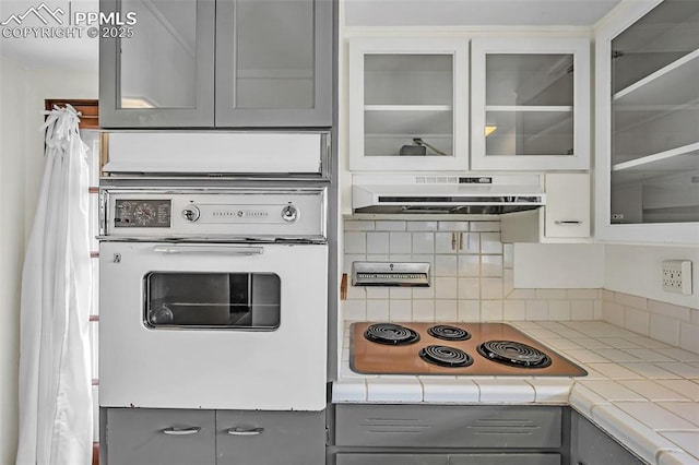 1624 Cheyenne Blvd, Colorado Springs, CO 80906 - kitchen featuring gray cabinetry, glass insert cabinets, electric stovetop, and oven