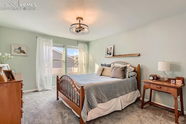 carpeted bedroom with baseboards and a chandelier