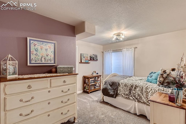 bedroom with a textured ceiling and light carpet