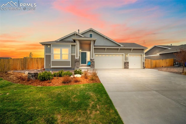 craftsman house with a front lawn, driveway, an attached garage, and fence