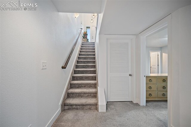 stairway with carpet and baseboards