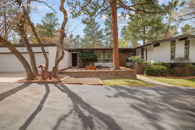 single story home with concrete driveway and an attached garage