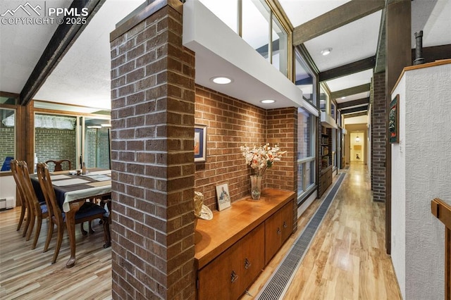 hall with recessed lighting, beam ceiling, and light wood-style flooring