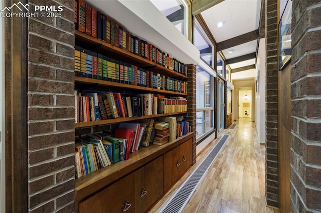 hallway with recessed lighting, beamed ceiling, and light wood-type flooring