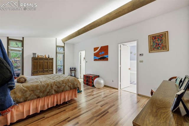 bedroom featuring baseboards and light wood-style flooring