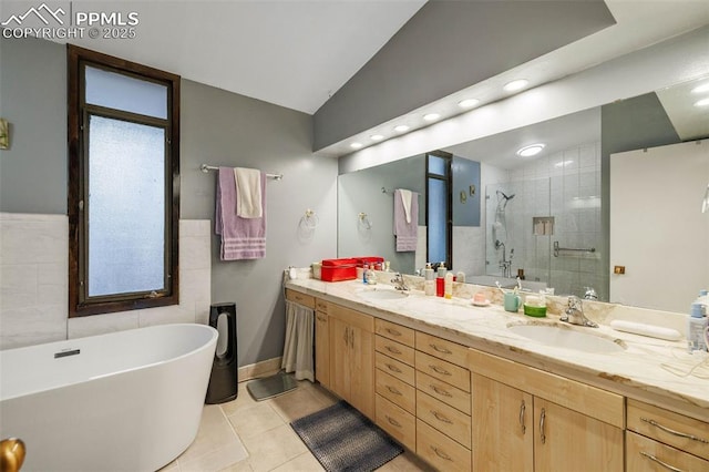 bathroom featuring a freestanding tub, a sink, lofted ceiling, and a stall shower