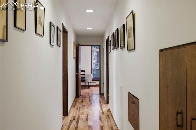 hall featuring recessed lighting, light wood-style floors, and a baseboard heating unit