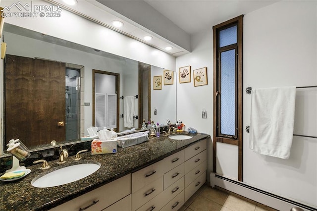 full bathroom featuring a sink, tile patterned floors, a baseboard radiator, and a stall shower