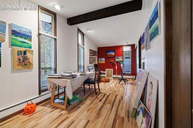 dining space featuring light wood-style floors, baseboard heating, and beamed ceiling