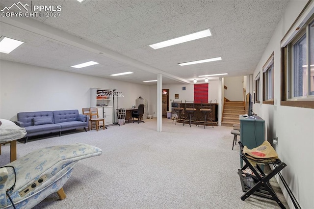 living area featuring carpet flooring, stairway, and a dry bar