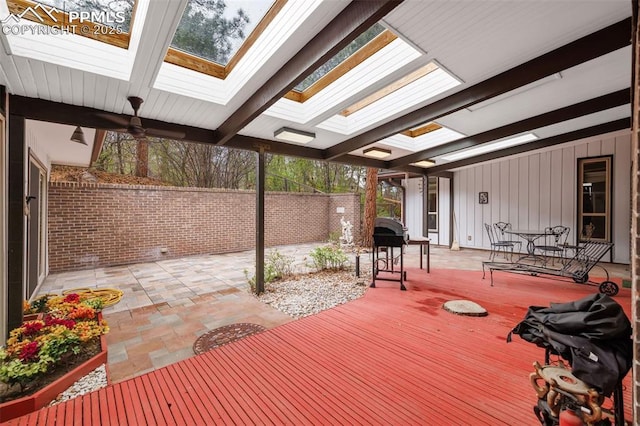 wooden deck with a fenced backyard and a patio area