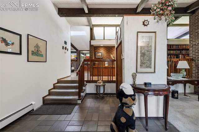 interior space featuring a baseboard heating unit, a wealth of natural light, and beam ceiling