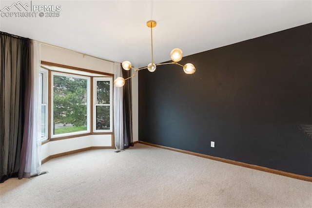empty room with baseboards, light colored carpet, an inviting chandelier, and visible vents
