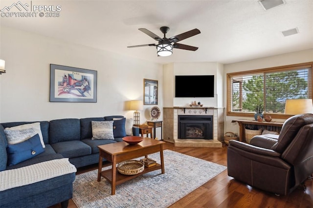 344 Mission Hill Way, Colorado Springs, CO 80921 - living room with ceiling fan, a tile fireplace, visible vents, and dark wood-type flooring
