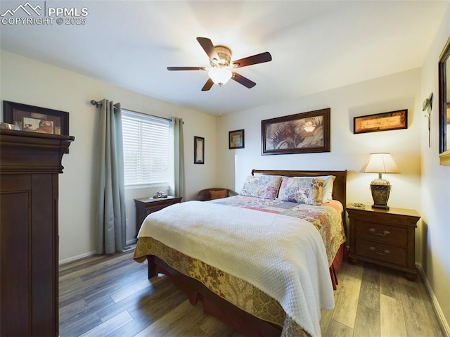 bedroom with light wood-style floors, ceiling fan, and baseboards