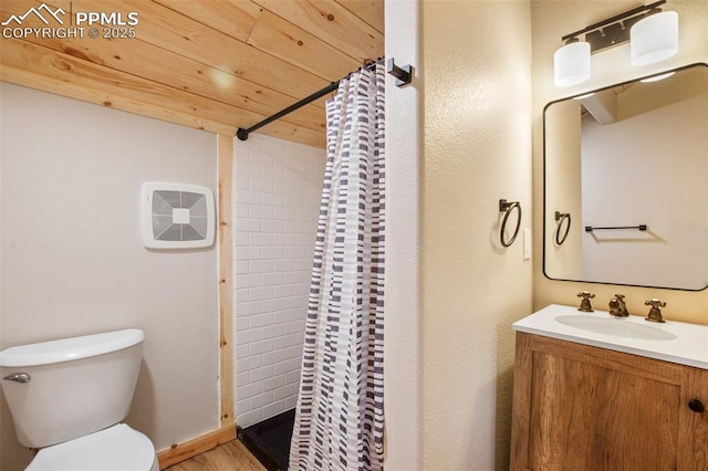 full bathroom with vanity, toilet, wood finished floors, and a stall shower