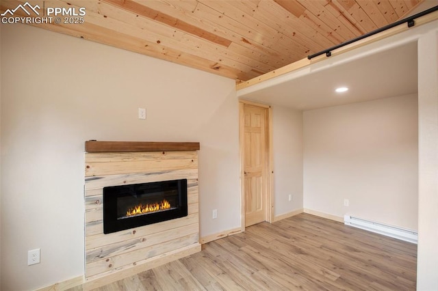 unfurnished living room featuring a fireplace, recessed lighting, baseboards, wood finished floors, and a baseboard radiator