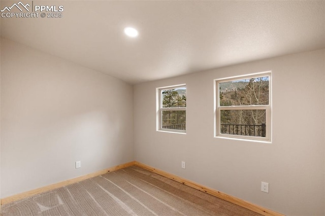 carpeted empty room with baseboards and recessed lighting