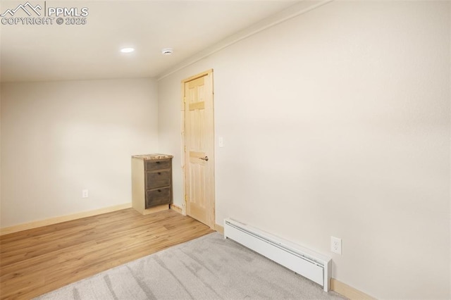 spare room featuring baseboards, baseboard heating, recessed lighting, and wood finished floors