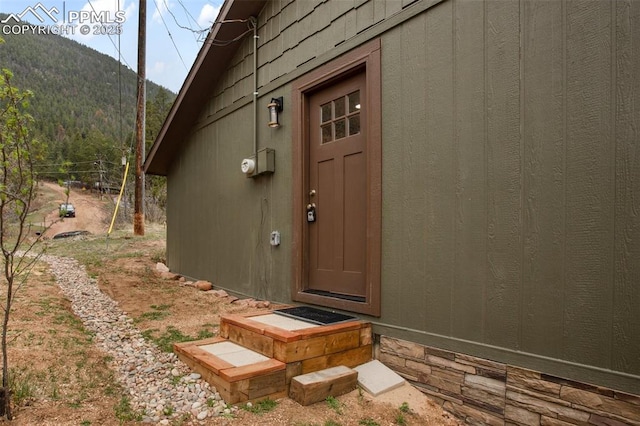 entrance to property featuring fence and a mountain view