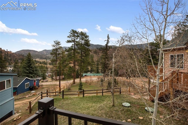 view of yard with fence and a mountain view