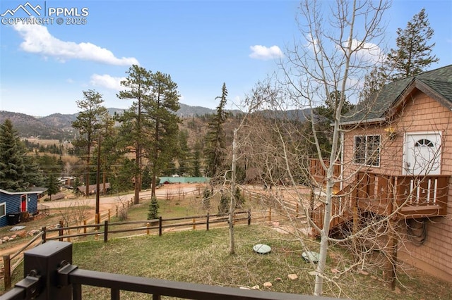 view of yard with a mountain view and fence