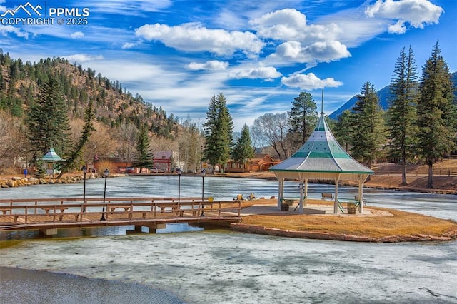 view of property's community with a water view and a gazebo