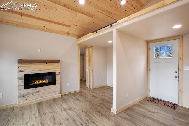 interior space with baseboards, recessed lighting, and wood finished floors