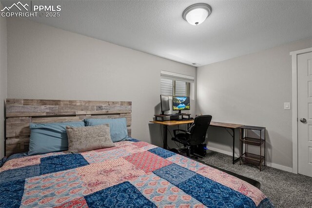 bedroom with carpet, a textured ceiling, and baseboards