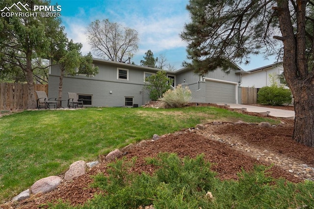 exterior space featuring fence, driveway, and a yard