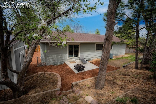 back of property featuring fence, a patio area, a shingled roof, and central air condition unit