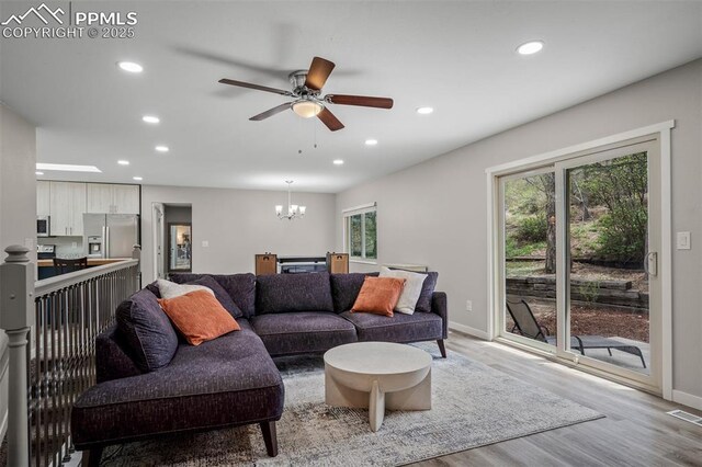 living room featuring a wealth of natural light, recessed lighting, and light wood-type flooring