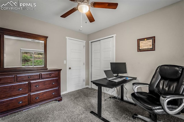 carpeted office featuring a ceiling fan and baseboards