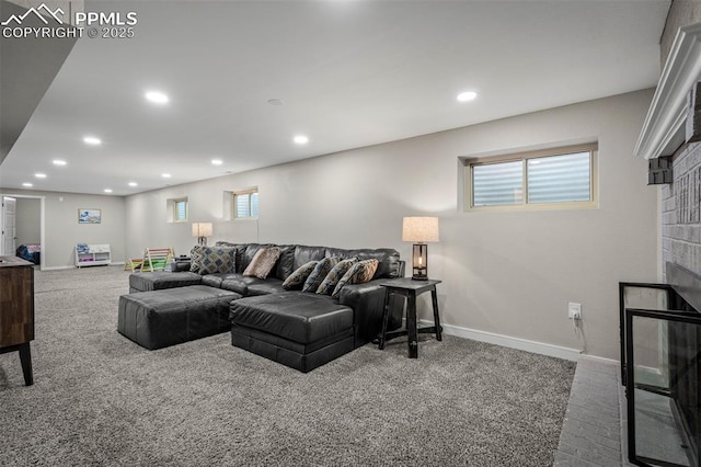 carpeted living area featuring recessed lighting, a glass covered fireplace, and baseboards