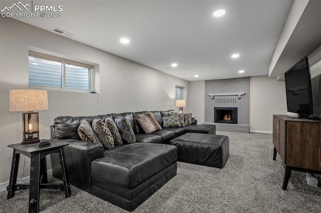 carpeted living area with a brick fireplace, recessed lighting, visible vents, and plenty of natural light