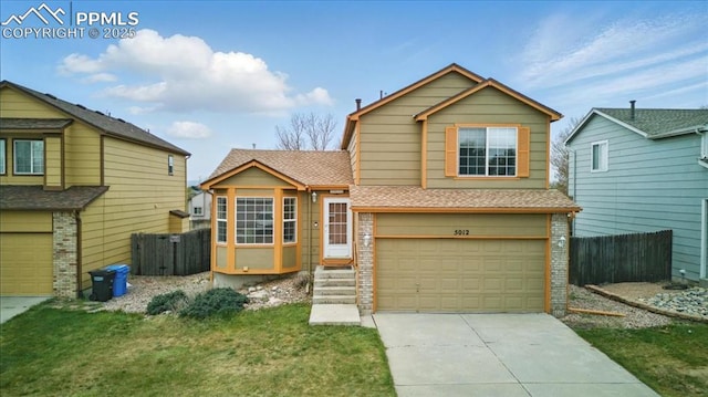 5012 Chaise Dr, Colorado Springs, CO 80923 - view of front of property with brick siding, a garage, concrete driveway, and roof with shingles
